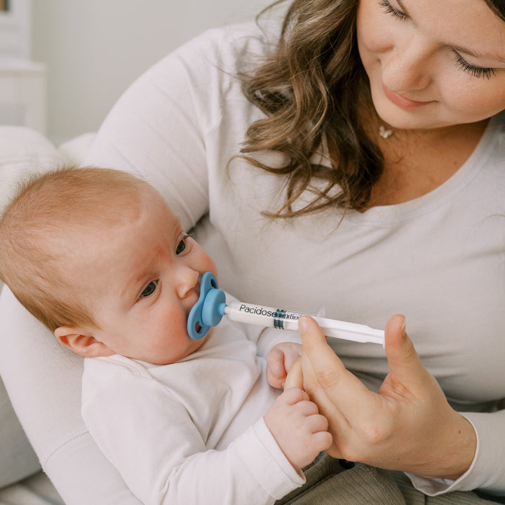 https://cdn.shopify.com/s/files/1/0659/5860/9120/files/Lifestyle_Pacidose_with_baby_stage1_blue_5.jpg?v=1754451041